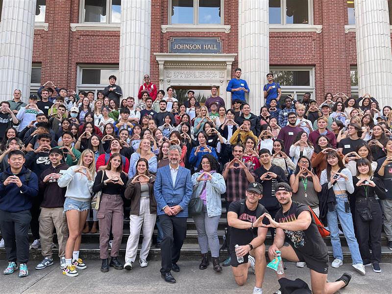 International students pose with Patrick Philips outside Johnson hall.