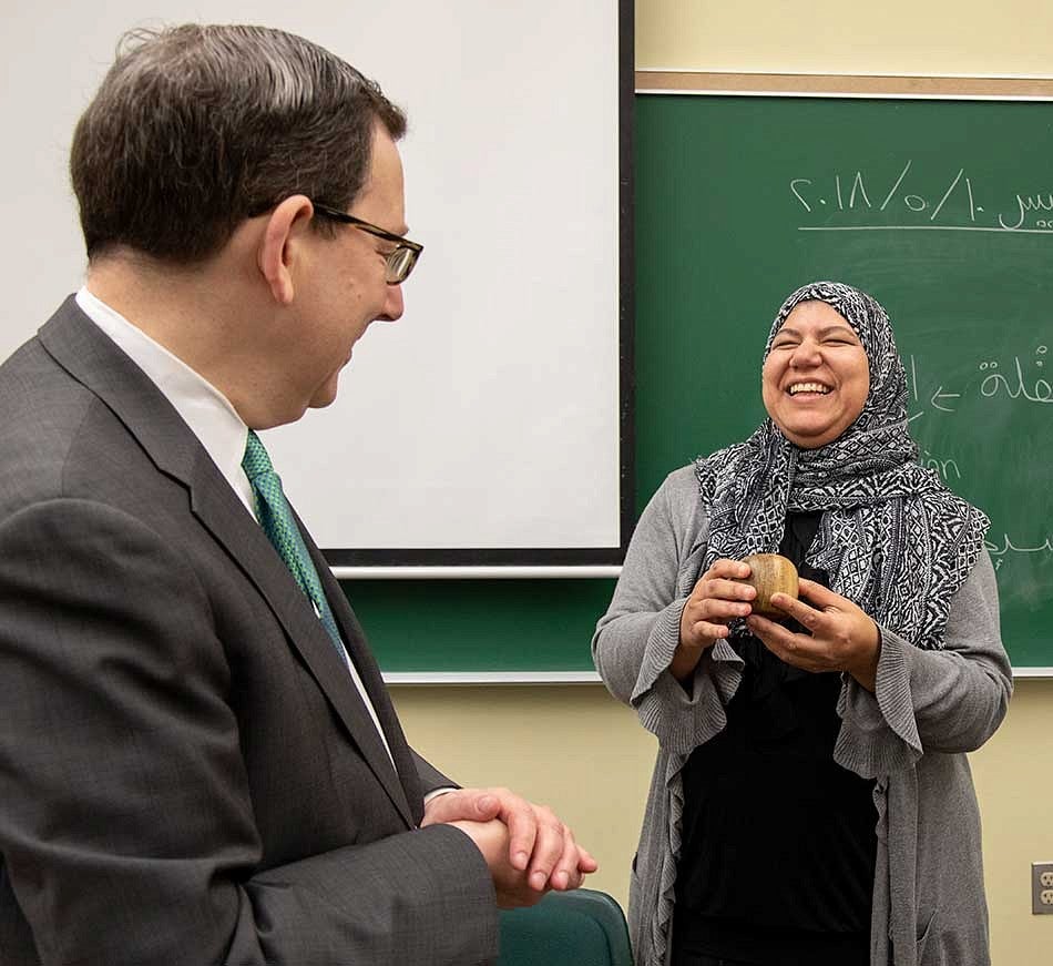 President Michael Schill presenting Hanan Elsherif with the Distinguished Teacher Award