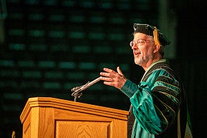Patrick Phillips talks on stage at the convocation.