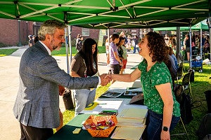 Patrick Phillips talks to one of the students at the tents.