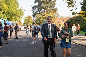 Interim President Patrick Phillips and ASUO Student Body President Luda Isakharov walk down 13th avenue to talk with students and street faire vendors
